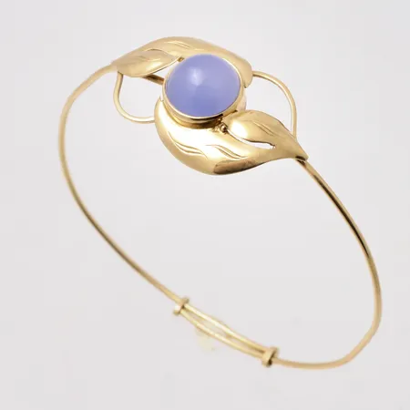 Armring i 18K guld, 16--20cm, ställbar, bredd 1,2-22,6mm, tillverkad av Stigbert för Heribert Engelbert AB, bruttovikt 9,18g, ca nettovikt 6,77g.