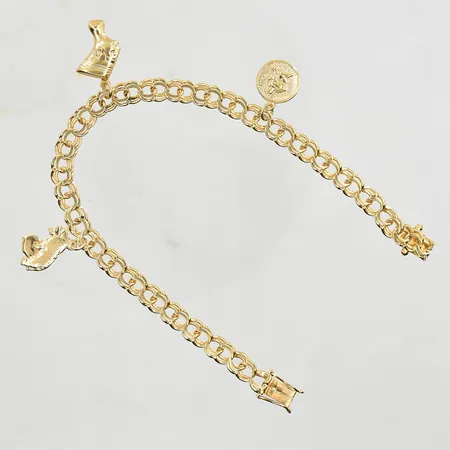 Armband Bismarck med 3 berlocker, längd 19½ cm, länkens bredd 5 mm, 18K. Vikt: 13,2 g