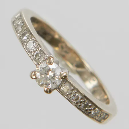 Ring, briljantslipade diamanter 1xca0,18ct, ca W/VS, + 10xca0,02ct, stl 16, bredd 2-4mm, gravyr, vitguld, behov av omrodering, 18K Vikt: 3,1 g