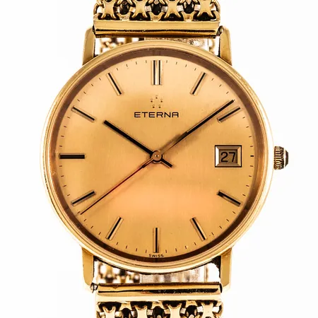 Herrur Eterna i 18K guld med band x-länk i 18K. Boett Ø 33,5 mm, safirglas, quartz. Bandets bredd 18,5 mm, total längd 21 cm. Sliten krona. Bruttovikt: 50,7g. 