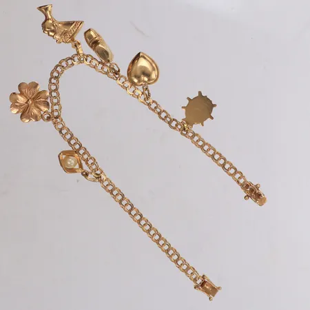 Armband med sex berlocker, längd 18,5cm, 18K Vikt: 10,9 g