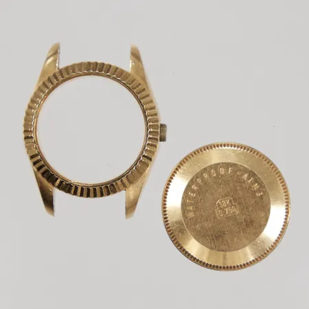 Två delar av klockboett, 18K  Vikt: 16,2 g