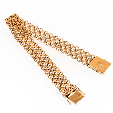 Armband, X-länk i 18K guld. Det är 19,5 cm långt, 11,5 mm brett och väger 22,1g. Kistlås. Stämplat CBH (Hallbergs), Köpings stadsstämpel, 18K, N9 (1963) & kattfot. Fint skick. 