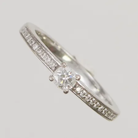 Ring vitguld, behöver rodieras, 1xca0,18ct, 20xca0,005ct, Ø17½, bredd: 3,8mm, 18K, 3,6g.
