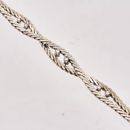 Armband i 18K vitguld, 18,7cm, bredd 4,8-8mm, 6st diamanter, 0,14ct, enligt gravyr, importstämpel, vikt 18,95g.