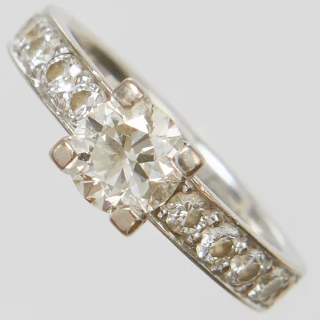 Enstensring med diamant 1 x 1,00ct, H/VS1, laserinskription: IGI 468192715 samt 10 diamanter 0,60ctv enligt gravyr, Ø17¼, bredd: 3,4-6,2mm, personlig gravyr, Schalins, vitguld, 18K Vikt: 5,7 g