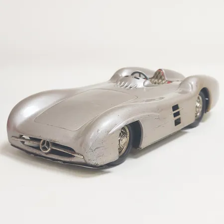 Leksaksbil  Mercedes Benz W196, made in West Germany, saknar delar samt batteri, bucklig och repig. 