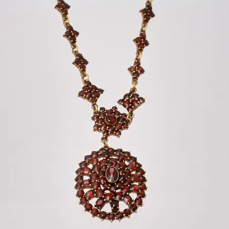 Collier i gulfärgad metall med granater, 36,5cm, bredd 6,3-10,5mm, hänge, mått 25,5x46,7mm, springring.