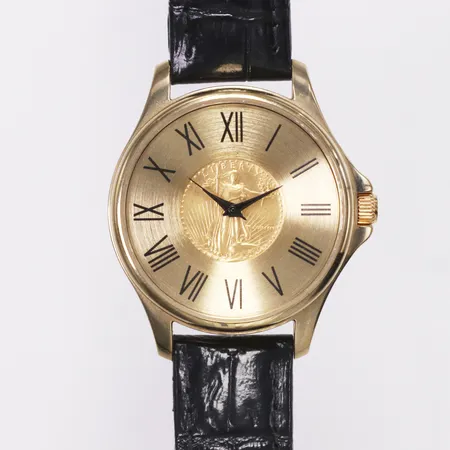 Herrur, Coinwatch Samlerhuset The 1986 Gold Eagle Watch, guld på stål, quartz, numrerad 9/499, 1/10 OZ Gold Eagle, läderband, inga tillbehör. 