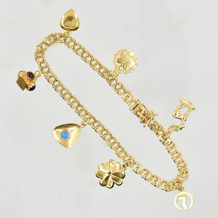 Armband Bismarck med 7 berlocker, längd 19 cm, länkens bredd 4 mm, klämskador på berlocker förekommer, 18K. Vikt: 13,4 g