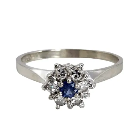 Ring, 18K vitguld, Safir 0,10ct - graverat på skenans insida, Diamanter 6 st - totalt 0,19ct - graverat på skenans insida, Trege Guldsmedsaktiebolaget (GGG), svensk kontrollstämpel, Ø mellan 18¼ och 18½ mm, bredd 2-7 mm, fint skick, stenar utan anmärkning Vikt: 2,6 g