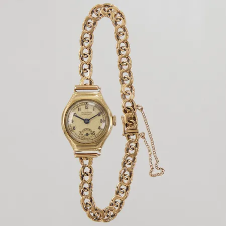 Damur 14K, ca Ø21mm, Record Geneve, manuell, integrerad länk, längd inklusive uret ca 18cm, tilltryckt boett, länk i 18K, Bruttovikt: 17,9g.