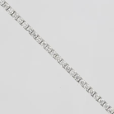 Armband, rivière, med 56s briljantslipade diamanter totalt 4,86ct enligt gravyr, kvalitet ca TW-(F-G)/SI, varav 7st stenar möjligen syntetiska, längd 17cm, en buckla, 14K vitguld Vikt: 7,3 g