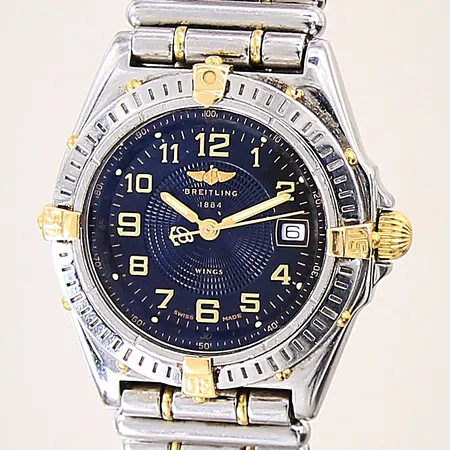 Damur Breitling Wings Lady, stål/guld, quartz, ref-nr: B67050, serie-nr: 6609, Ø31mm, datum, safirglas, rouleaux länk, något repig boett samt länk, certifikat Tyskland 1999, manual, box