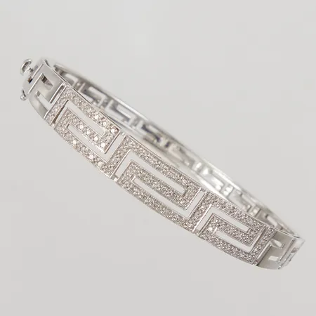 Armring med åttkantslipade diamanter ca 76x0,005ct, inre omkrets 18,5cm, bredd 5,2-9,5mm, vitguld 18K,  Vikt: 20,3 g