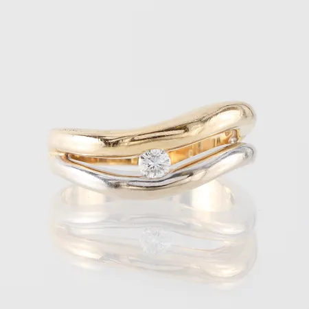 Ring tvåfärgad med diamant ca 0,13ct, storlek 18 mm, bredd 3.4-7.7 mm, ojämn form, 18k. Vikt: 5,7 g