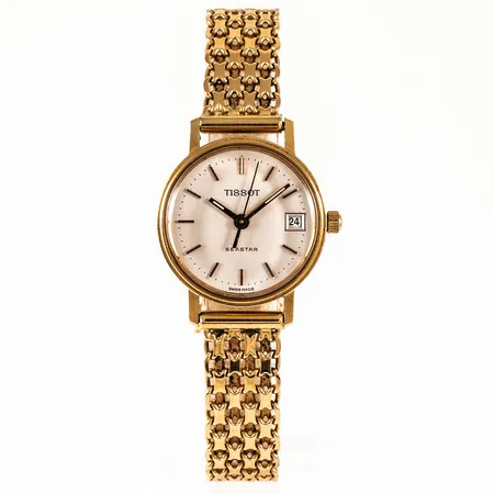 Damur, Tissot Seastar i 18K guld med urband X-länk i 18K, längd 18 cm. Boett Ø 22 mm, datum, quartz, gravyr "Kungl patriotiska sällskapet", namn och årtal. Går ej, batteribyte krävs? Bruttovikt: 26,1g.  