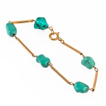 Armband i 18K guld: Stavar samt turkosa stenar. Det är 19 cm långt, 1,7 - 8 mm brett och väger 7,2g. Stavarnas längd 16,5 cm.