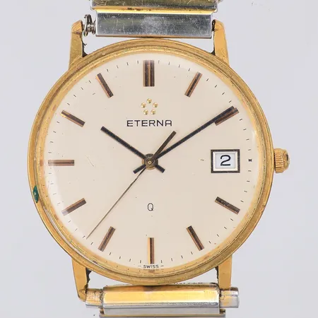 Herrur Eterna Q, 18K, gravyr, quartz, Ø34mm, flexarmband stål, defekt, av, står still Vikt: 0 g