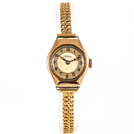 Damur MIBA i 14K guld med 18K band. Boett 23,7 x 21 mm med gravyr. Fläckig urtavla. Manuellt urverk. Plastglas. Bandlängd 18,5 cm. Bruttovikt 20,2g.