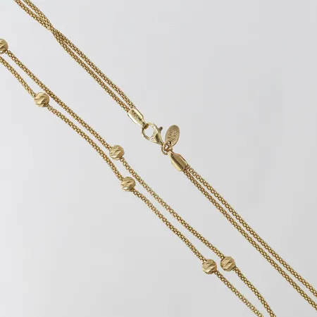 Stämpla Collier med integrerade kulor, tvåradigt, längd 44,5cm, bredd 1,3-4mm, 14K.  Vikt: 7 g