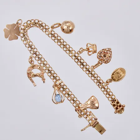 Armband X-länk med 8 berlocker, längd ca 18cm, bredd ca 6mm, Esto Ab Guldvarufirman 1965, 18K Vikt: 16,5 g