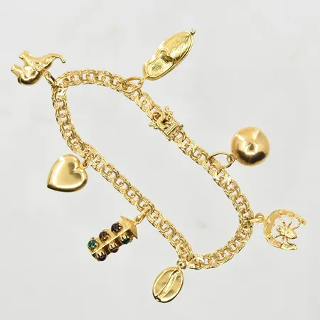 Armband Bismarck med 7 berlocker, längd 18½ cm, länkens bredd 5 mm, 18K. Vikt: 21,1 g