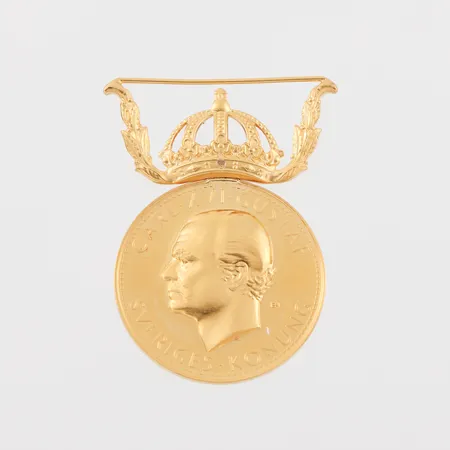 Medalj 23/18k. Vikt: 14,9 g