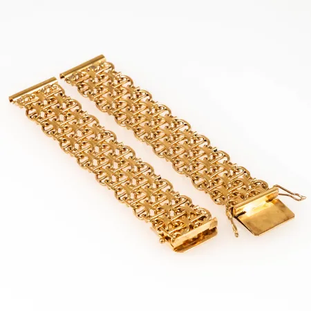 Urband X-länk i 18K guld. Det är 18 cm långt, 17 mm brett och väger 39,4g. Kistlås. 