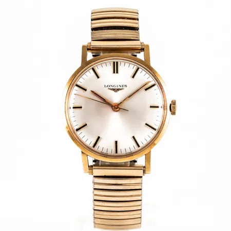 Herrur Longines i 18K guld med flexiband i metall. Boett Ø 34 mm, manuell, svaga repor på plexiglas, företagslogga, namn- och årsgravyr. Fungerade vid testtillfället. Bruttovikt: 55,5g.