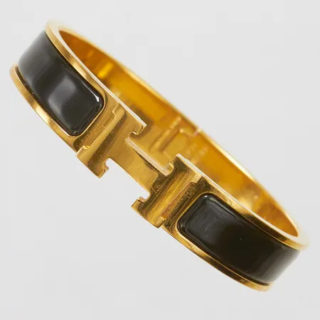 Armband, Hermès Clic Clac H, gulmetall med svart emalj, ca 55x45mm, märkt Hermès Made in France,  snr FI0250, bredd: 11,5mm, ytliga repor, dustbag, manual, box, inga övriga tillbehör