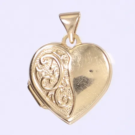 Hänge/medaljong i form av hjärta, invändigt med två glasskivor, höjd 20mm inkl öglan, enstaka små bucklor, 18K Vikt: 1,5 g