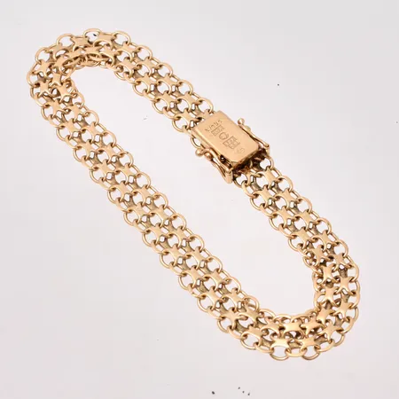 Armband i 18K guld, 18,5cm, X-länk, bredd 8,2mm, tillverkad av Stockholms Stads Arbetsvårdsbyrå, år 1972, vikt 11,94g.