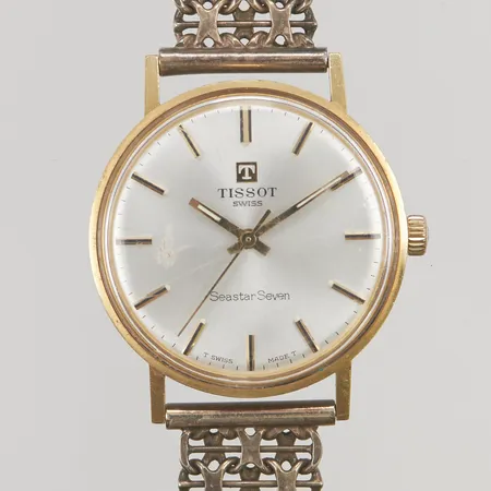 Tissot Seastar Seven, manuell, 18K, Ø33mm, graverad boett, repigt plexiglas, länk i silver 830/1000, bruttovikt 49g.