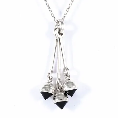 Hänge Efva Attling "Dancing Queen" med konslipade Onyxer. Hängets längd 60 mm, bredd 10 - 20 mm. Kedja Spetsslipad ankarlänk 70 cm medföljer. Silver 925/1000. Vikt: 19,2g. Mycket fint skick. Originalask medföljer.