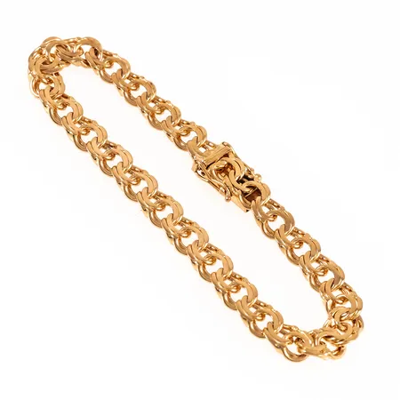 Armband Bismarck i 18K guld. Det är 19,5 cm långt, 7,3 mm brett och väger 19,9g. Kistlås. Stämplad K9 (1960), SR (Segir AB, Köping), 18K, kattfot.