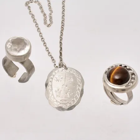 3st smycken i tenn, 2st ringar, och ett hänge med kedja i metall.