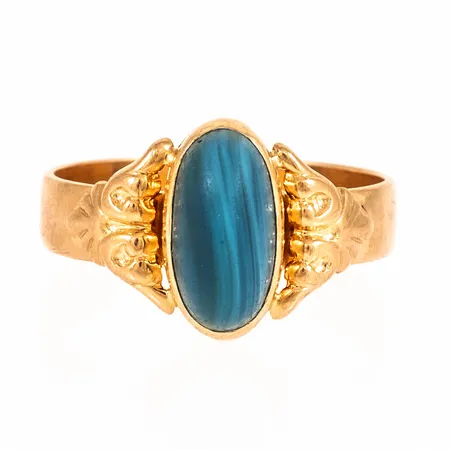 Ring i 18K guld med en blå slaggsten (matt). Den är 4,5 - 12,8 mm bred, är i storlek 19½ och väger 4,8g. 