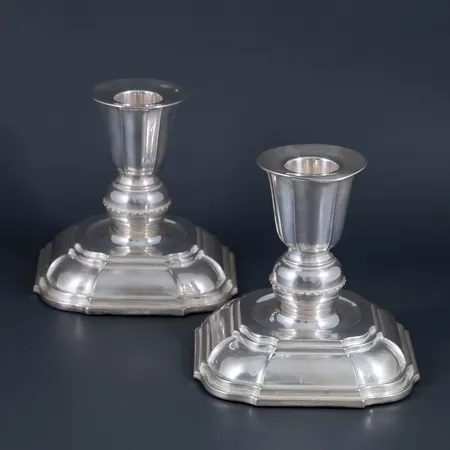 Ett par ljusstakar i silver. De är 95 mm höga. Ojämnhet på ena manschetten. Framstår putsade med stålull. Stämplade Ceson, Göteborg, S9 (1968). Fyllda fötter. Bruttovikt 527g.