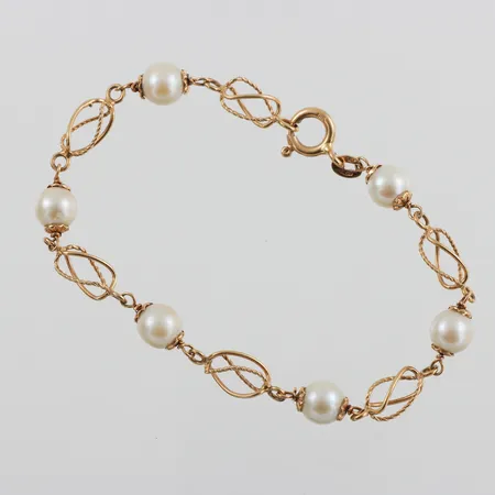 Armband 18k med pärlor,längd ca 19 cm,bredd 0.5-6.9 mm. Vikt: 7,6 g