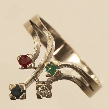 Ring med diamant ca 0,05ct, rubin, safir samt smaragd, troligen syntetiska, stl 17¼, bredd 14mm, Markströms Guldsmeds Ab K G, år 1974, vitguld, 18K  Vikt: 4,6 g