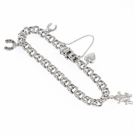 Armband Bismarck i silver med fyra berlocker. Det är 19 cm långt, 7,5 mm brett och väger 15,8g. Kistlås med säkerhetskedja. Bruksskick. 3 stenar (markasiter) saknas i berlock, gravyr under låstunga. 