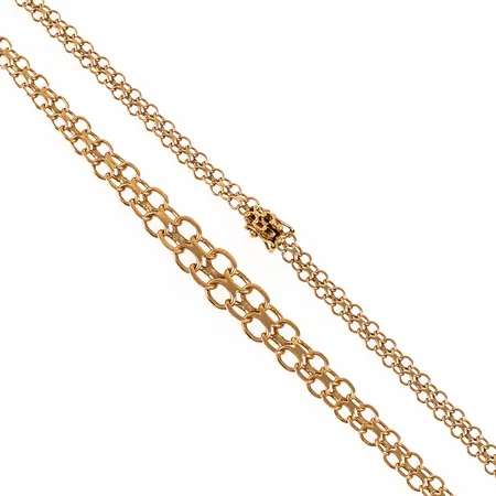 Colliér X-länk i 18K guld. Det är 45,5 cm långt, 5 - 10,5 mm brett och väger 16,8g. Kistlås. 