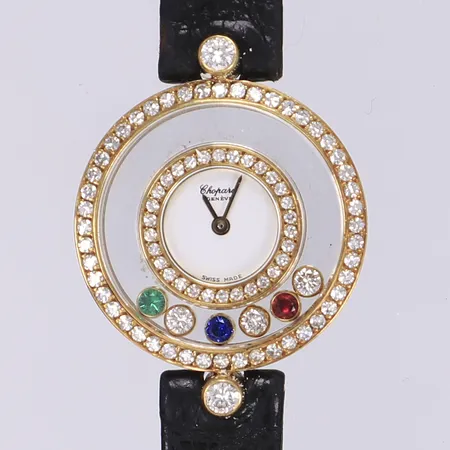 Damur Chopard Happy Diamonds, Ø24mm, quartz, ref 299859-4097, nr 20/3950, boett 18K, med diamanter 2x ca 0,08ct, 48x ca 0,01ct, 30x ca 0,005ct, samt under glas 3x ca 0,03ct samt röd, blå och grön sten troligen rubin, safir och smaragd, med box samt nyckel för tidsinställning, i behov av batteribyte, ej funktionstestad, defekt läderband