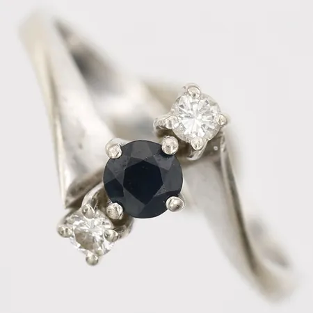 Ring med safir samt diamanter 2 x ca 0,05ct, stl: 16¼, bredd: 2-9mm, 14K vitguld.  Vikt: 2,3 g