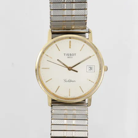  Herrur Tissot Goldrun, Ø34mm, quartz, , datum, plexiglas, boett i 18K guld, flexiband i stål,  "För nit och redlighet i rikets tjänst", manual, etui. 