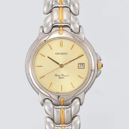 Damur Orient plastglas, Ø34mm, quartz, stål, viklås, färgsläpp på urtavlan