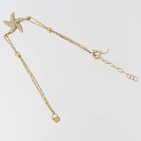 Armband med integrerade hängen och vita stenar, ca 13cm, länk och lås defekt. 14K Vikt: 1,6 g