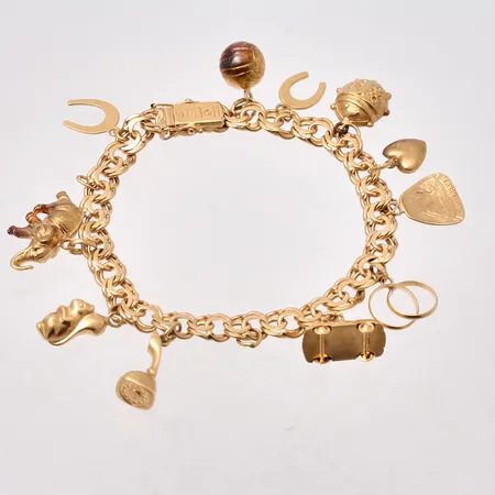  Armband i 18K guld, 17,5cm, Bismarck, bredd 6,5mm, 10st berlocker, tillverkad av C A Mattinsons Ringfabrikation, år 1958, vikt 25,3g.