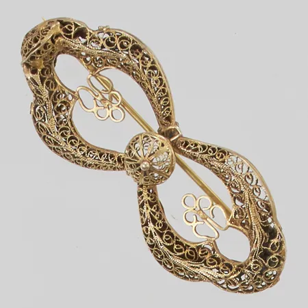 Brosch i förgylld metall 59x25mm, defekter.